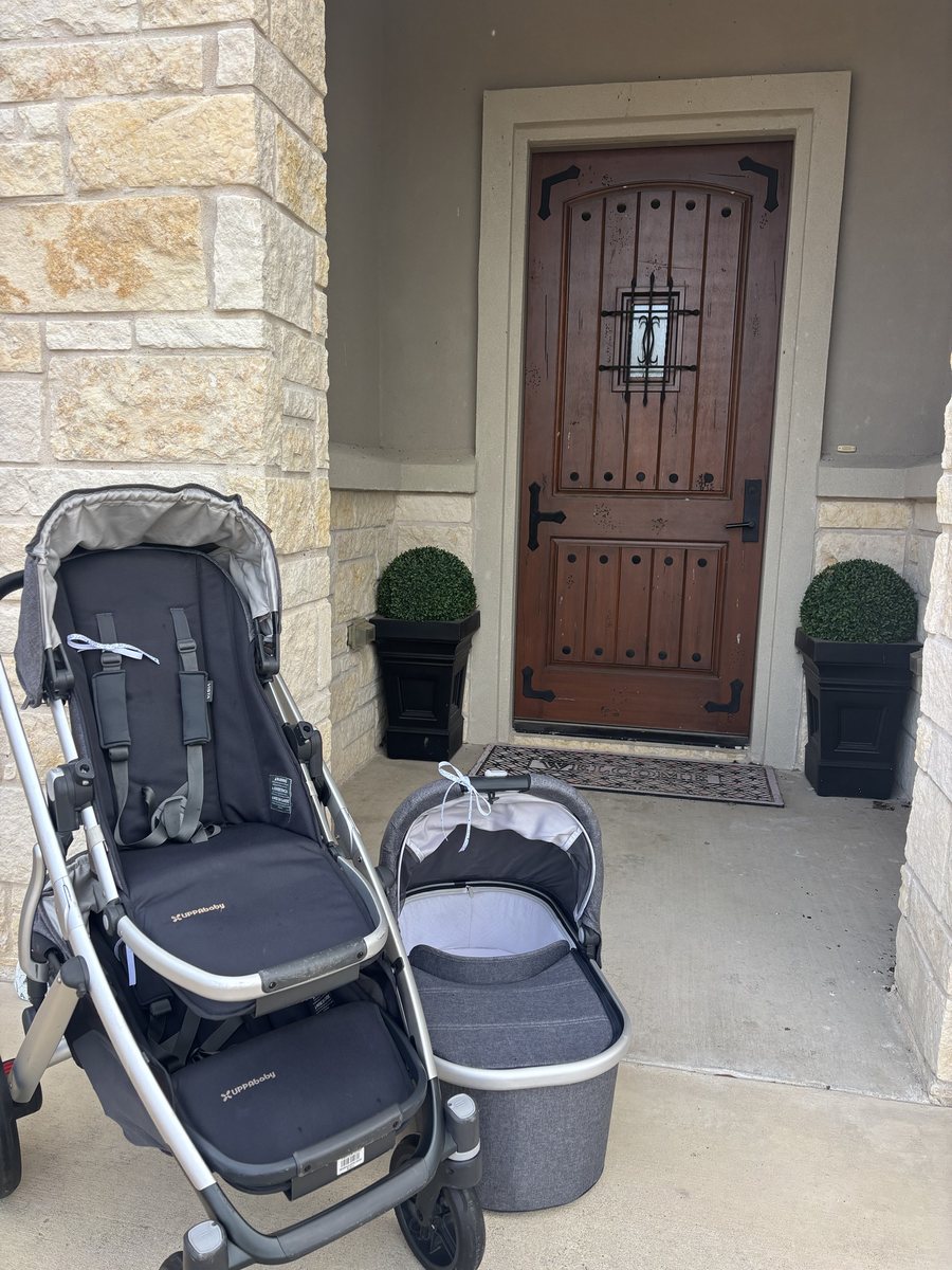 An UPPAbaby stroller and bassinet on a front porch